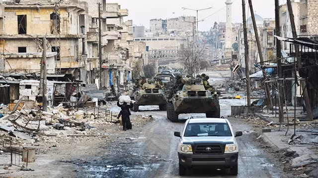 Một thị trấn trong vùng xung đột tại tây nam Syria. Ảnh: BLOOMBERG