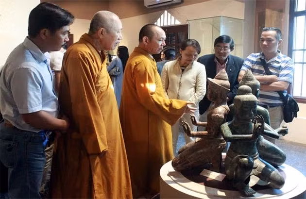 Thượng tọa Thích Huệ Vinh (thứ 3 từ trái sang) giới thiệu cho khách tham quan.
