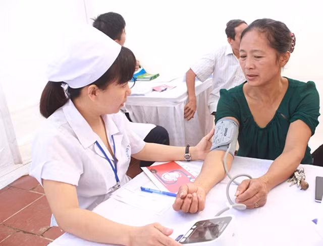 Bác sĩ Viện Tim mạch Việt Nam - Bệnh viện Bạch Mai tư vấn sức khỏe cho người dân xã Phù Linh, huyện Sóc Sơn (Hà Nội).Ảnh: KIM SƠN