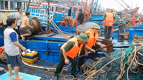 Cán bộ, chiến sĩ Đồn BP Cửa khẩu Nha Trang giúp ngư dân Cảng Hòn Rớ chằng buộc, neo đậu phương tiện.