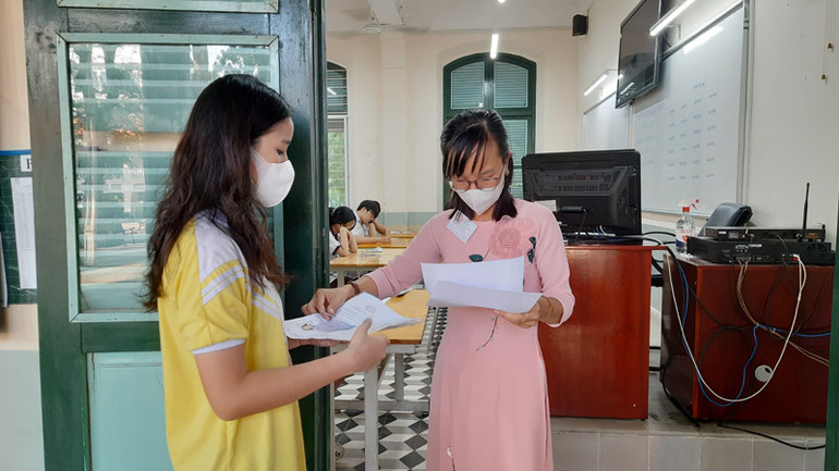 Thí sinh tại điểm thi Trường trung học phổ thông Lê Quý Đôn, quận 3, Thành phố Hồ Chí Minh làm thủ tục vào phòng thi.