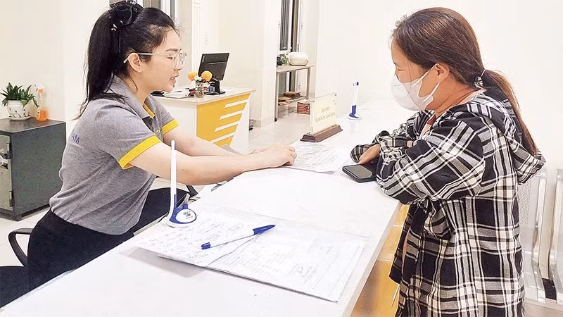 Người dân tìm hiểu, tham gia bảo hiểm xã hội tự nguyện tại quầy kinh doanh Bưu điện thành phố Cao Bằng.