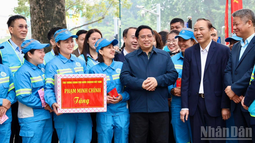 Thủ tướng Chính phủ Phạm Minh Chính thăm, động viên, chúc Tết đội ngũ công nhân vệ sinh môi trường của Công ty URENCO tại Vườn hoa Lê Trực. (Ảnh: Hải Linh)