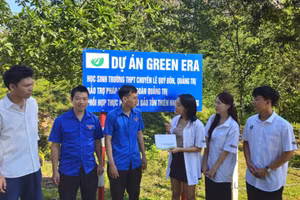Bốn em trong nhóm Dự án Green Era trao tiền, phối hợp Đoàn Thanh niên Khu bảo tồn Thiên nhiên Đakrông chăm sóc vườn cây. (Ảnh: Quang Huy)