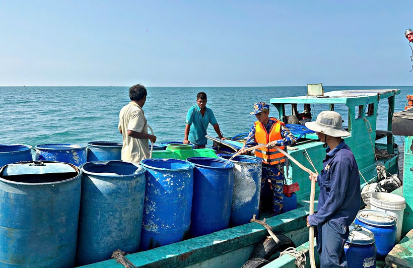 Người dân đảo Hòn Chuối sử dụng thùng phuy vận chuyển nước từ Tàu 527 lên đảo. (Ảnh do Vùng 5 Hải quân cung cấp)