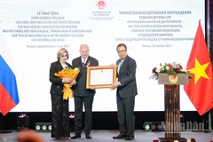 Thay mặt Chủ tịch nước Cộng hòa xã hội chủ nghĩa Việt Nam, Đại sứ Đặng Minh Khôi trao Huân chương Hữu nghị tặng ông Anatoli Artamonov. (Ảnh: XUÂN HƯNG)