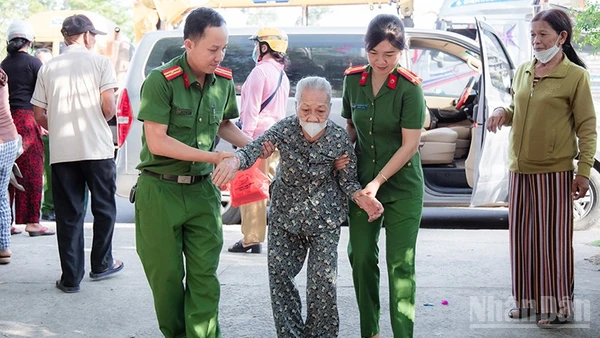 Cán bộ, chiến sĩ Công an xã Phú Ninh hỗ trợ người cao tuổi đi làm giấy tờ cá nhân.