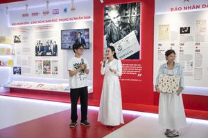 Các bạn trẻ tham gia hoạt động hỏi đáp tại gian trưng bày Báo Nhân Dân. (Ảnh: SƠN TÙNG)