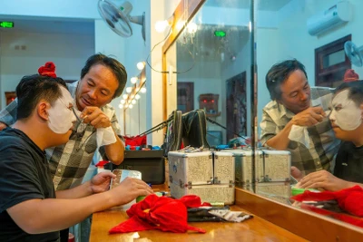 Nghệ sĩ Ưu tú Mai Ngọc Nhân góp ý với diễn viên trong lúc hóa trang vẽ mặt tuồng chuẩn bị biểu diễn. (Ảnh: MỸ HÀ)