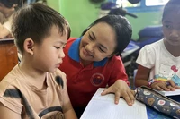 Chiến sĩ tình nguyện “Hoa phượng đỏ” của Thành phố Hồ Chí Minh kèm cặp, hỗ trợ thiếu nhi học tập, rèn luyện ngày hè. (Ảnh Thành đoàn Thành phố Hồ Chí Minh)