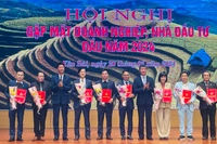 Chủ tịch Ủy ban nhân dân tỉnh Trần Huy Tuấn trao chứng nhận đầu tư cho các doanh nghiệp mới. (Ảnh THANH SƠN)