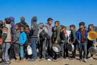 Người dân xếp hàng chờ được phát thực phẩm cứu trợ tại Rafah, Dải Gaza. (Ảnh: THX/TTXVN)