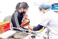 Tiêm vắc-xin phòng bệnh sởi cho trẻ tại Trạm Y tế phường Vĩnh Tuy (quận Hai Bà Trưng). (Ảnh NGUYỄN VÂN)