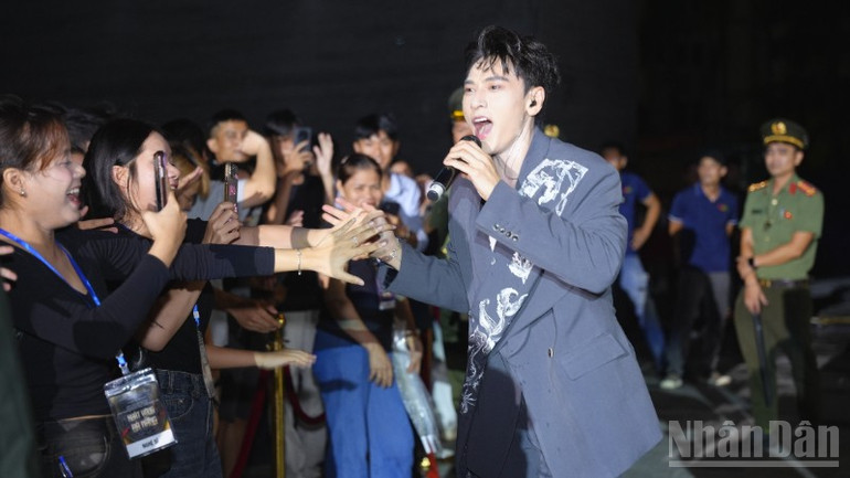 Nhiều khán giả đội mưa xem chương trình. (Ảnh: ANH ĐÀO) ndo_br_dsc6390-9780.jpg