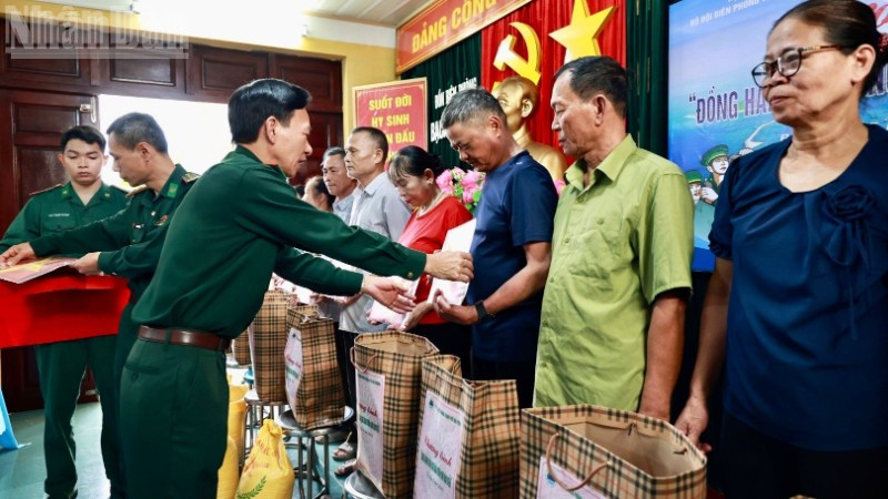 Thượng tá Nguyễn Văn Lập, Chủ nhiệm chính trị Bộ đội Biên phòng thành phố Hải Phòng trao quà và tặng cờ Tổ quốc cho các hộ dân trên đảo.