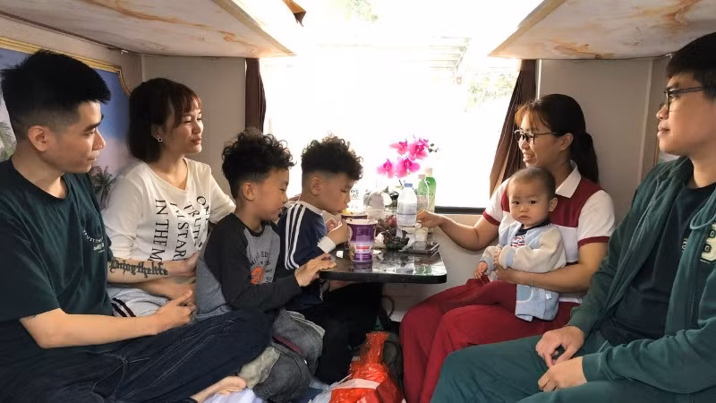 Gia đình chị Nguyễn Minh Thu, Nguyễn Thu Trang quây quần trong khoang tàu.