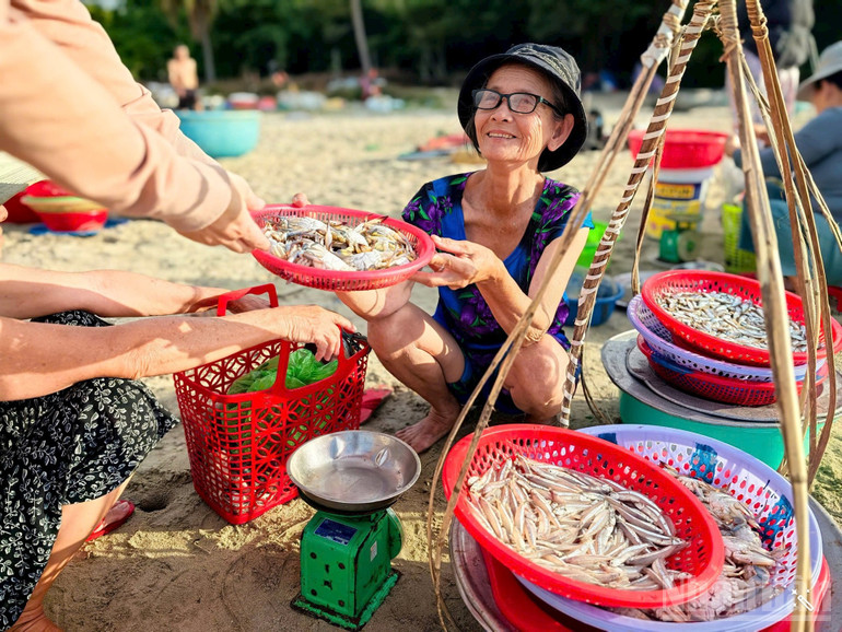 Bà Chu Thị Mùi mua cá từ thuyền thúng và bán lại ngay tại bãi biển. ndo_br_ba-mui.jpg