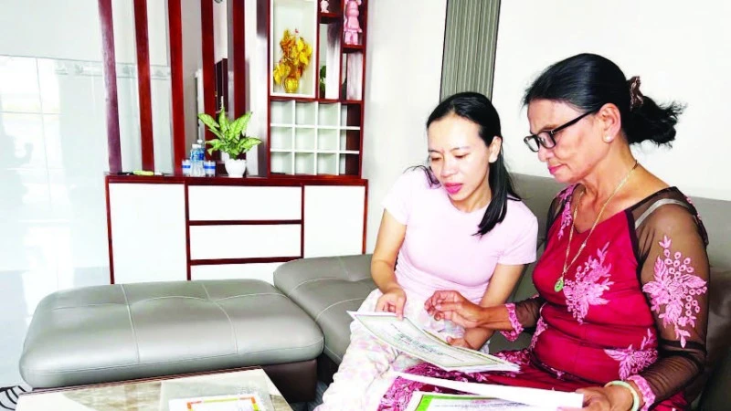 Bà Dư Thị Ánh (68 tuổi) bên những tấm bằng khen, giấy chứng nhận thành tích học tập của con cháu được gìn giữ cẩn thận.