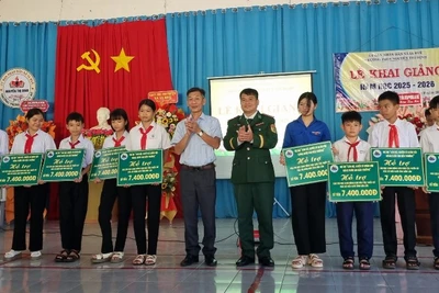 Đại diện lãnh đạo Ban Chỉ huy Bộ đội Biên phòng tỉnh Đắk Lắk và chính quyền địa phương trao quà tặng cho các em học sinh tại xã Ia Rvê.