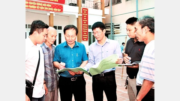 Cán bộ MTTQ phường Yết Kiêu, quận Hà Đông (Hà Nội) trao đổi, giám sát công việc cải tạo một công trình văn hóa. Ảnh: BÁ HOẠT