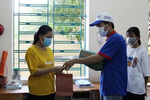 Đội hình “Tiếp sức mùa thi” tại điểm Trường THPT Phạm Phú Thứ hỗ trợ Thành Đoàn trao quà cho thí sinh.