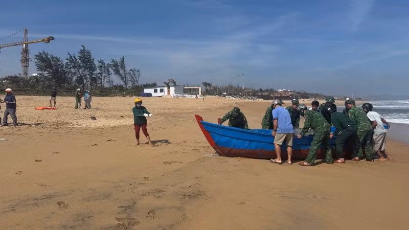 Cán bộ, chiến sĩ Đồn Biên phòng Tuy Hòa phối hợp người dân địa phương hỗ trợ trục vớt, đưa phương tiện gặp sự cố vào bờ an toàn.