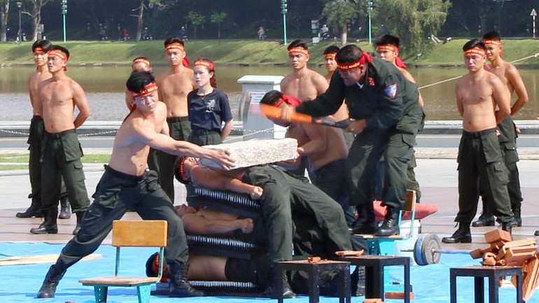 Lực lượng Bộ Tư lệnh Cảnh sát cơ động biểu diễn màn nằm lên bàn đinh, kê đập vỡ đá.