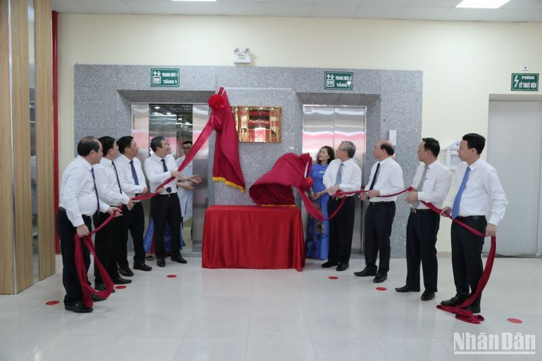 Các đại biểu thực hiện nghi thức gắn biển công trình kỷ niệm Ngày sinh Chủ tịch Hồ Chí Minh.