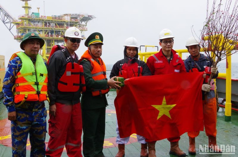 Cán bộ, chiến sĩ Hải đội biên phòng 2 chụp ảnh kỷ niệm với kỹ sư, người lao động đang làm việc tại giàn khoan mỏ khí Thái Bình.