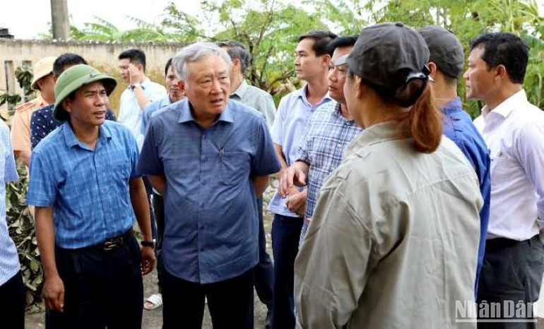 Đồng chí Nguyễn Hòa Bình thăm hỏi, động viên người lao động đang ứng trực tại trạm bơm An Quốc, huyện Kiến Xương (tỉnh Thái Bình).