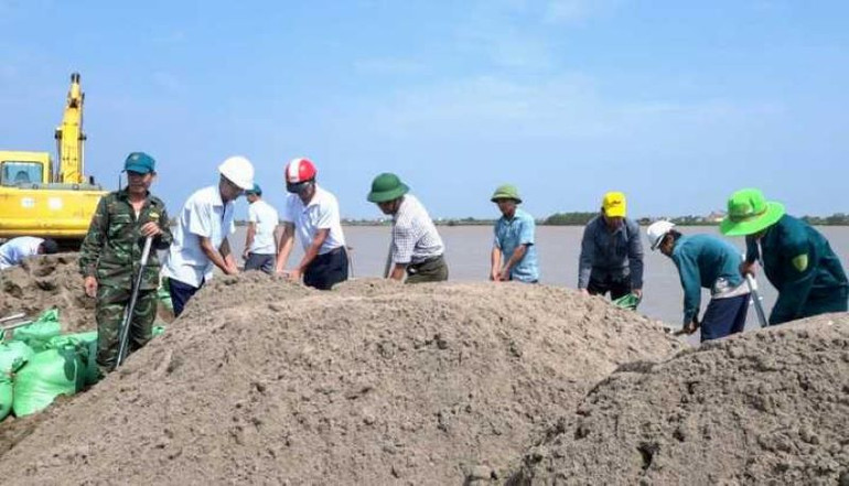 Khoảng 100 người thuộc xã Nam Hải và Nam Hà (huyện Tiền Hải) ra hiện trường tập trung xử lý giờ đầu sự cố tại kè Nội Lang. (Ảnh: TRÍ TUỆ)