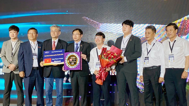 Chủ tịch Ủy ban nhân dân thành phố Đà Lạt và các thành viên đoàn đại biểu thành phố (áo trắng) tại Lễ trao giải Thành phố lễ hội châu Á và giải thưởng Lễ hội châu Á.