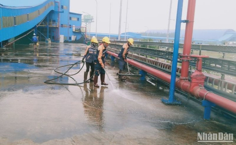 Lực lượng lao động đều đặn tưới nước trên bề mặt cầu cảng tiếp nhận than.