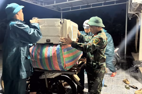 Lực lượng biên phòng hỗ trợ người dân di dời tài sản rạng sáng 13/9. (Ảnh: H.M)