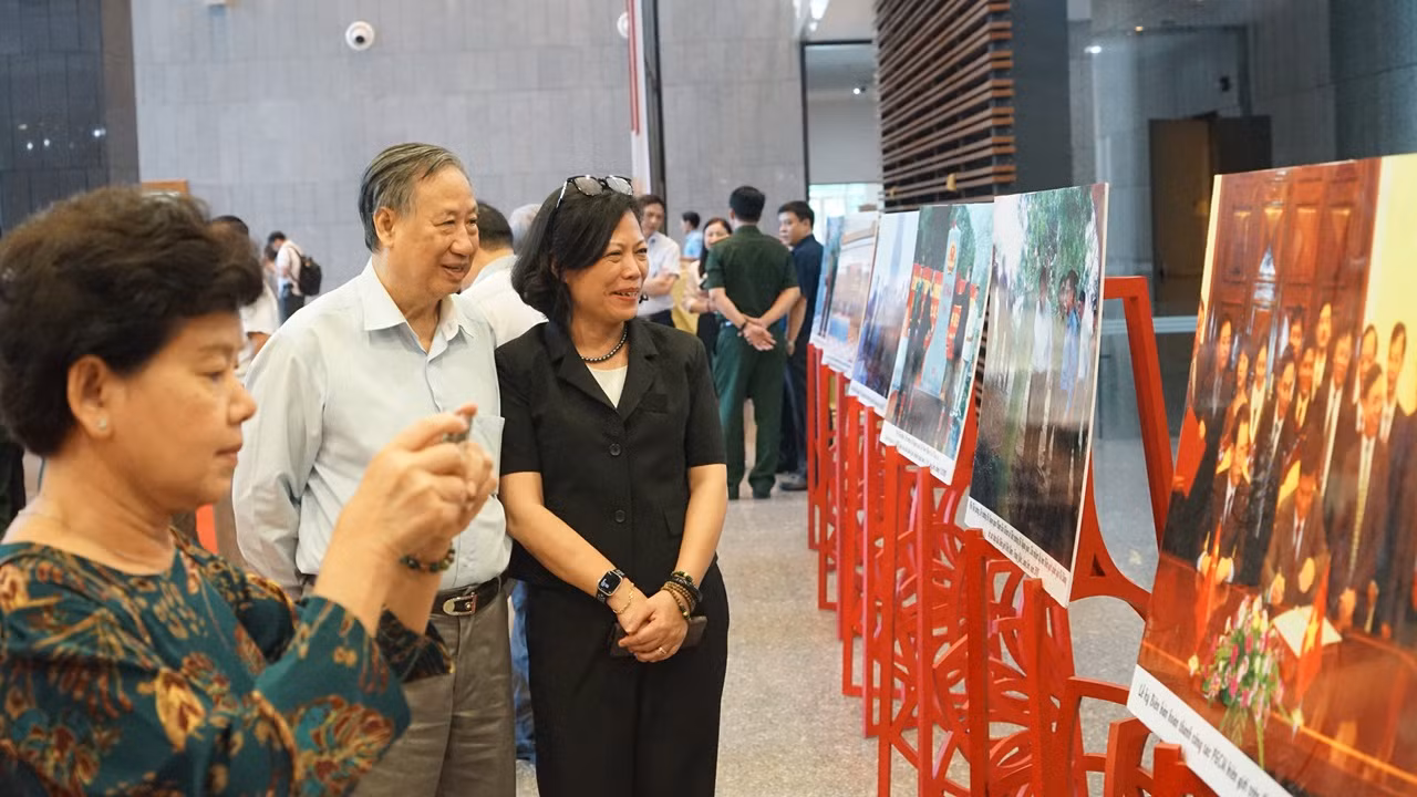 Các đại biểu tham quan triển lãm ảnh về công tác phân giới, cắm mốc biên giới trên đất liền Việt Nam-Trung Quốc bên lề hội nghị. (Ảnh: TRUNG HƯNG)