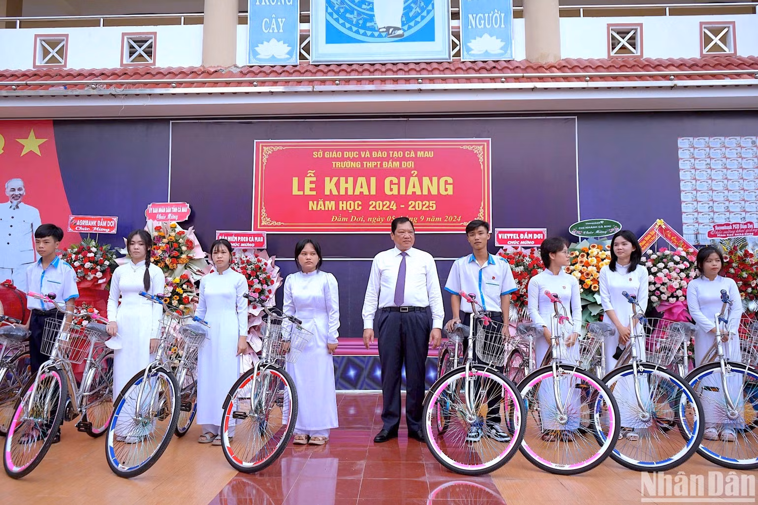 Phó Chủ tịch Ủy ban nhân dân tỉnh Cà Mau Lâm Văn Bi (giữa) trao tặng xe đạp cho các học sinh khó khăn Trường THPT Đầm Dơi (huyện Đầm Dơi, tỉnh Cà Mau) vào sáng 5/9.