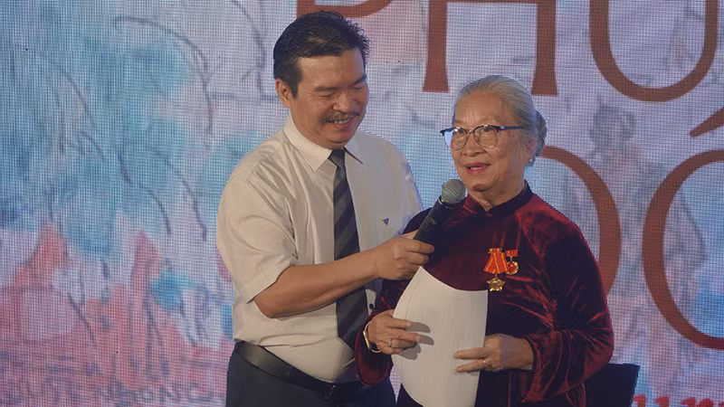 Bà Lê Thị Thu, vợ họa sĩ Huỳnh Phương Đông phát biểu tại buổi lễ khai mạc.