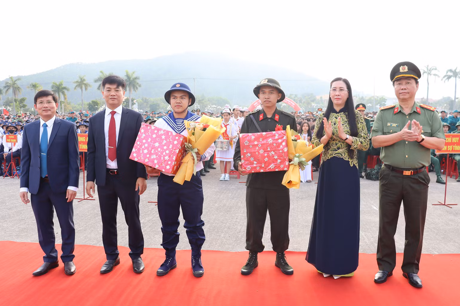 Tặng quà và hoa động viên cho đại diện các tân binh trước khi về đơn vị mới.
