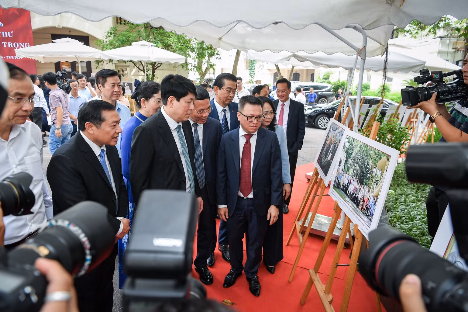 Tổng Biên tập Báo Nhân Dân Lê Quốc Minh, giới thiệu với đoàn tham quan về bức ảnh họp lớp của cố Tổng Bí thư Nguyễn Phú Trọng dưới gốc cây đa 71 Hàng Trống vào năm 2022. Ảnh: Thành Đạt