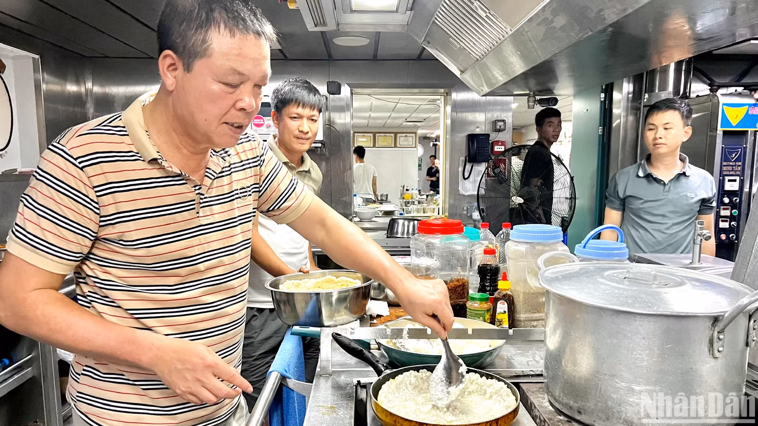 Chuẩn Đô đốc Phạm Như Xuân (bên trái), Phó Tư lệnh Quân chủng Hải quân tự tay chuẩn bị bữa ăn cho cán bộ, chiến sĩ, đại biểu trên tàu KN290.