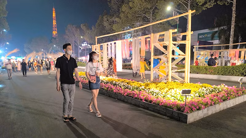 Du khách tham quan đường hoa. Ảnh: HỮU NGHĨA Du khách tham quan đường hoa. Ảnh: HỮU NGHĨA