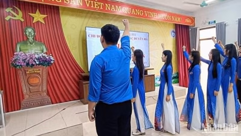Các đảng viên trẻ là học sinh khối lớp 12 Trường trung học phổ thông Bắc Duyên Hà (huyện Hưng Hà) giơ tay thề trước Quốc kỳ, Đảng kỳ và chân dung Chủ tịch Hồ Chí Minh.