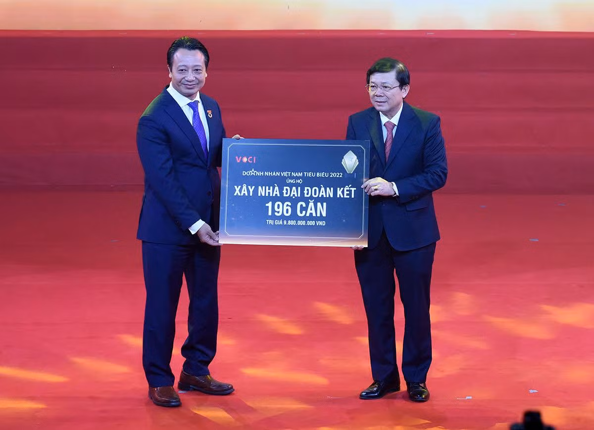 Đại diện các doanh nhân trao tượng trưng tiền ủng hộ xây dựng 196 căn nhà đại đoàn kết cho người nghèo, trị giá 9,8 tỷ đồng.