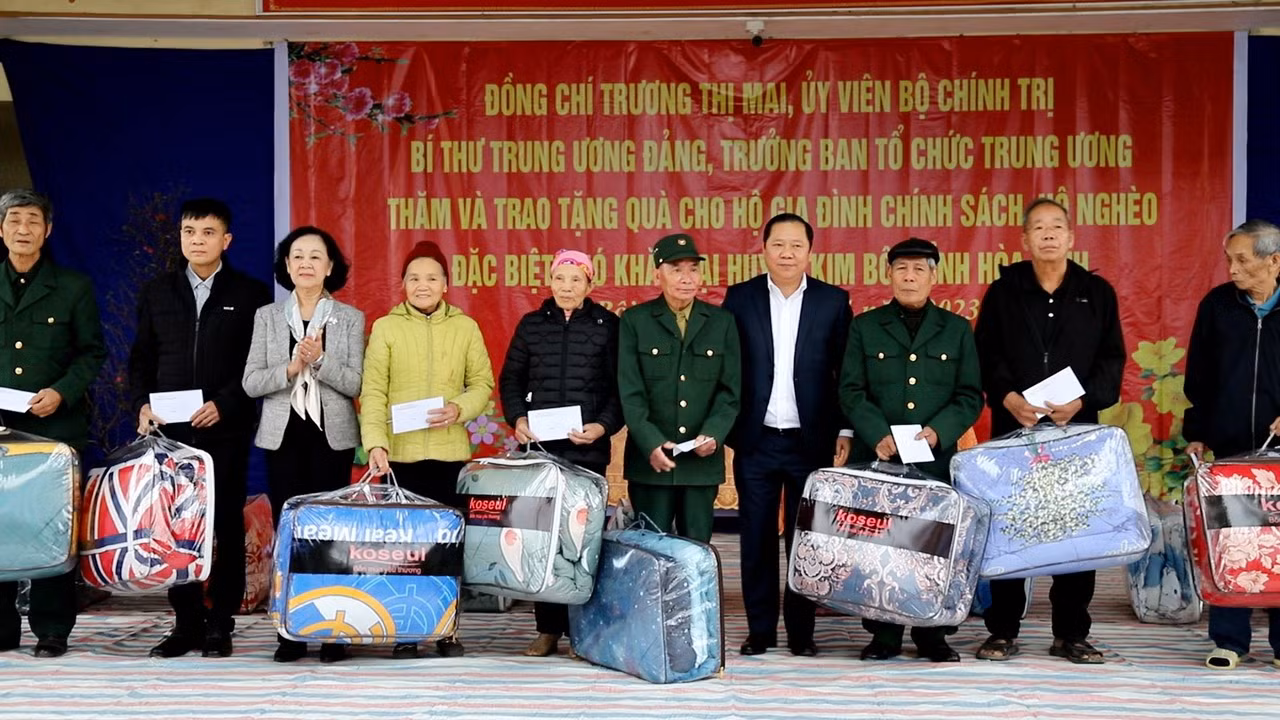 Đồng chí Trương Thị Mai (thứ 3 từ trái sang) và đồng chí Nguyễn Phi Long, Bí thư Tỉnh ủy Hòa Bình (thứ 4 từ phải sang) tặng quà cho các hộ gia đình khó khăn tại huyện Kim Bôi.