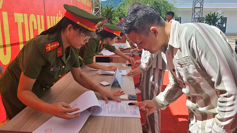 Giám thị Trại giam Thanh Cẩm hướng dẫn người được đặc xá hoàn tất thủ tục liên quan.