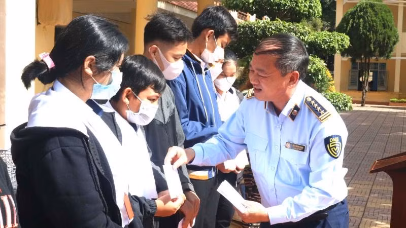 Cục trưởng Cục Quản lý thị trường Đắk Lắk Mai Mạnh Toàn trao học bổng cho các em học sinh dân tộc thiểu số có hoàn cảnh khó khăn đang theo học tại các trường trên địa bàn thành phố Buôn Ma Thuột.