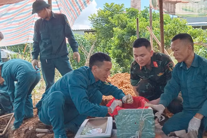 Lực lượng tham gia tiến hành khai quật, cất bốc 2 hài cốt liệt sĩ tại xã Chiềng Khoong, tỉnh Sơn La. (Ảnh: THỌ SƠN)