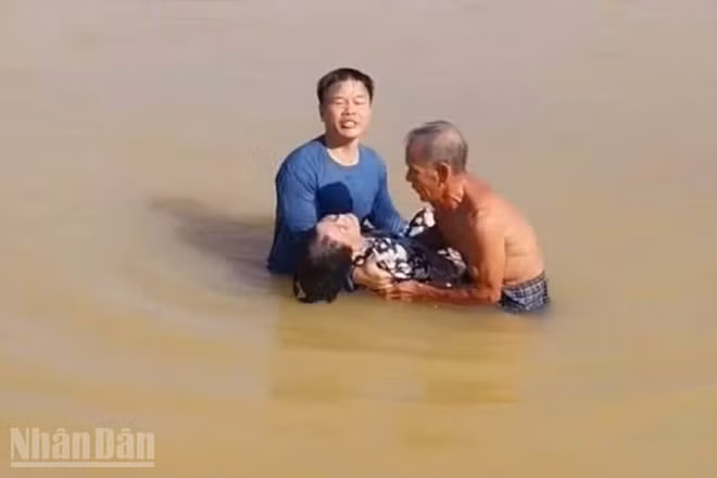 Thượng tá Lê Diệt cùng người dân cứu bà TTL trên sông Hương sáng 2/10. (Ảnh: Q.T)