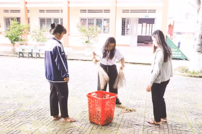 Học sinh Trường THPT Dân tộc nội trú Nơ Trang Lơng, tỉnh Đắk Lắk quét dọn vệ sinh khuôn viên nhà trường phòng chống dịch bệnh.