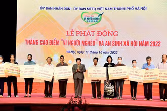 Trao trao kinh phí hỗ trợ xây nhà đại đoàn kết và phương tiện, công cụ sản xuất tặng các hộ nghèo. (Ảnh: Viết Thành)
